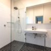 black and white tiled bathroom large shower head